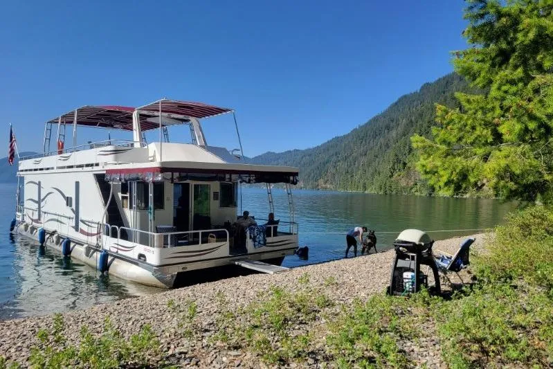 Slide: The Image of Houseboat docked on a scenic lake shore, Sailabration 64 model, 2015. - 2