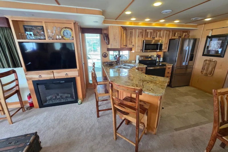 Slide: The Image of Luxurious 2015 Sailabration 64 houseboat kitchen with granite countertops and modern appliances. - 25