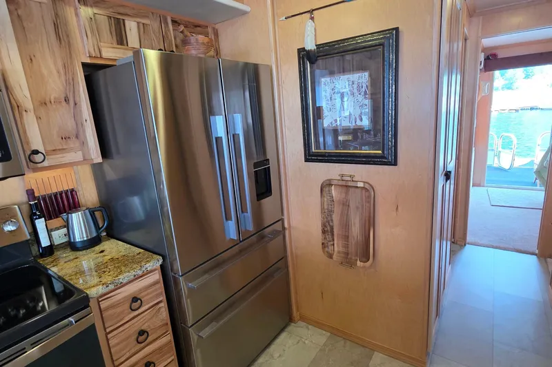 Slide: The Image of Modern kitchen in 2015 Sailabration 64 houseboat with stainless steel appliances and wood cabinetry. - 27