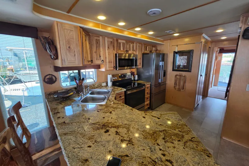 Slide: The Image of Luxurious 2015 Sailabration 64 kitchen with granite countertops and modern appliances. - 29