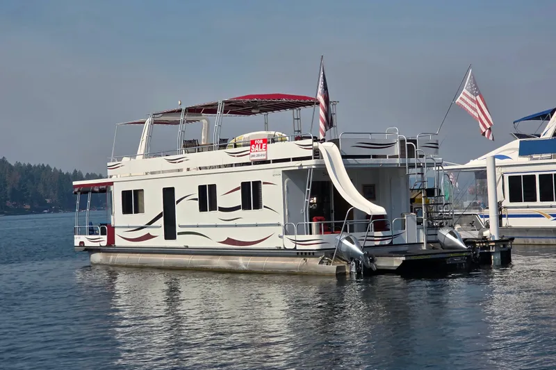 Slide: The Image of 2015 Sailabration 64 houseboat with slide, for sale on a serene lake. - 31