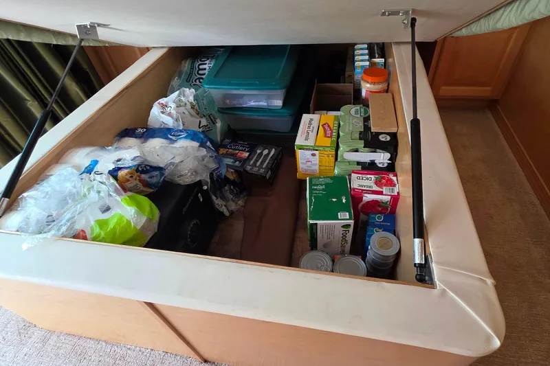 Slide: The Image of Under-bed storage in 2015 Sailabration 64, filled with household supplies and canned goods. - 35