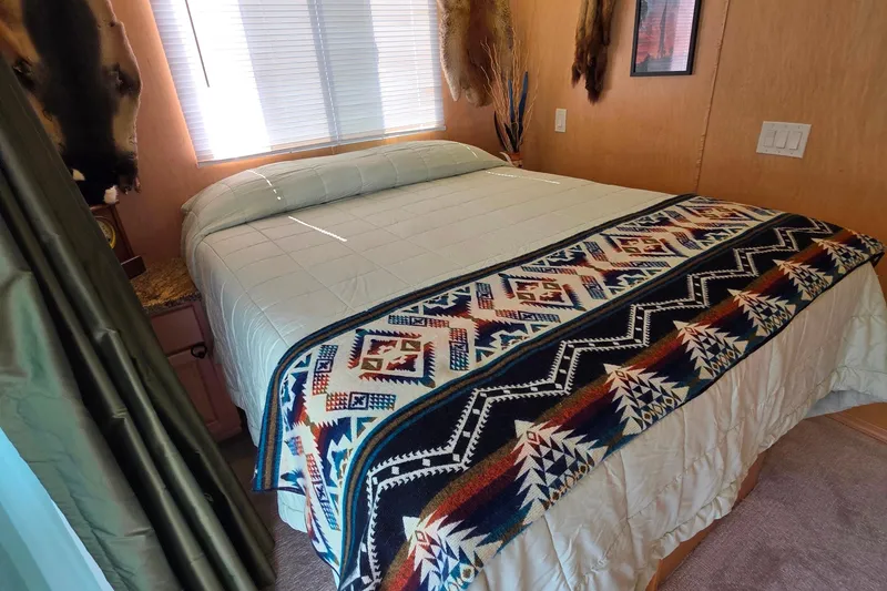 Slide: The Image of Cozy bedroom in 2015 Sailabration 64, featuring a patterned blanket and natural light. - 36