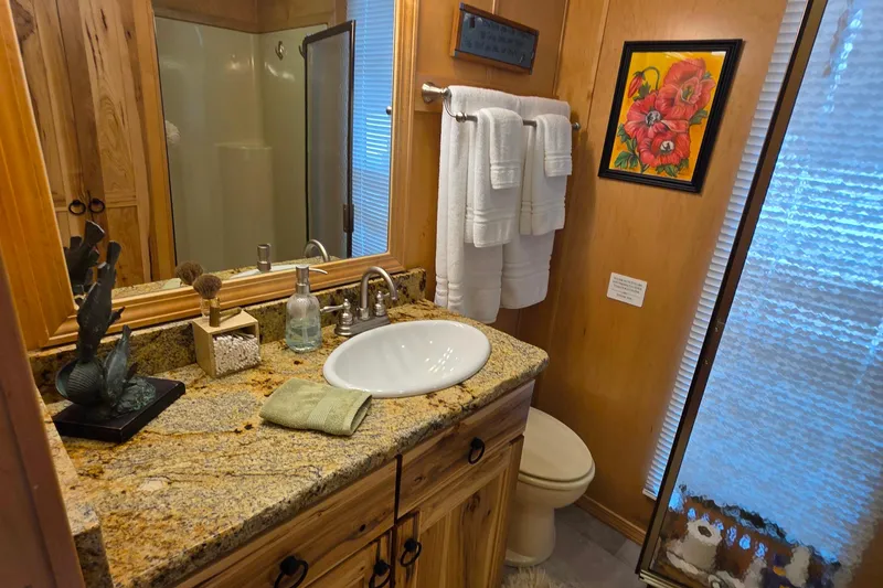 Slide: The Image of Luxurious 2015 Sailabration 64 bathroom with granite countertop, vessel sink, and vibrant floral artwork. - 37