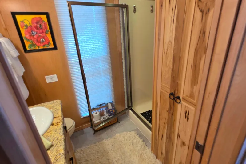Slide: The Image of Bathroom interior of 2015 Sailabration 64 with wooden cabinets and shower. - 38