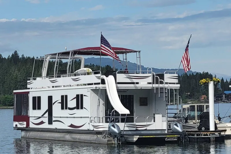 Slide: The Image of 2015 Sailabration 64 houseboat with slide, docked on a scenic lake. - 45