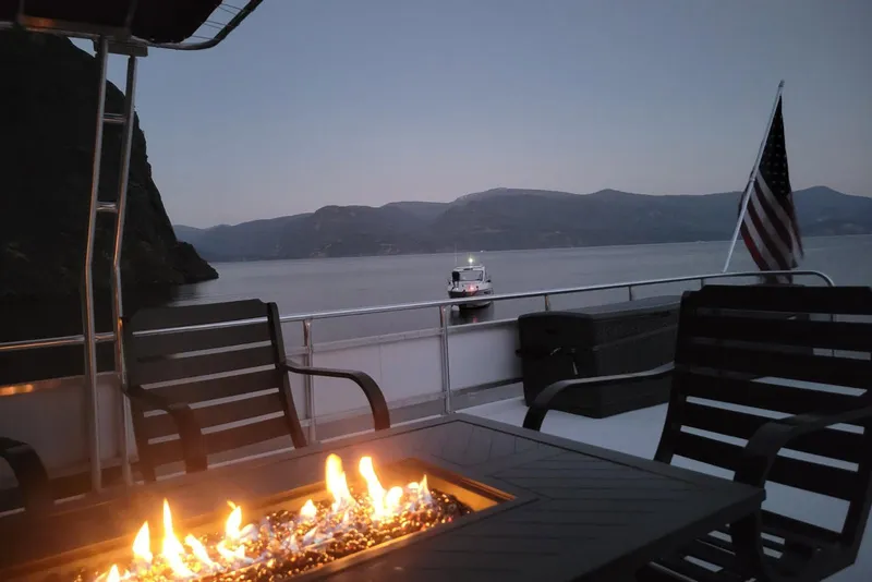 Slide: The Image of Luxurious 2015 Sailabration 64 yacht with fire pit, lake view, and American flag. - 48