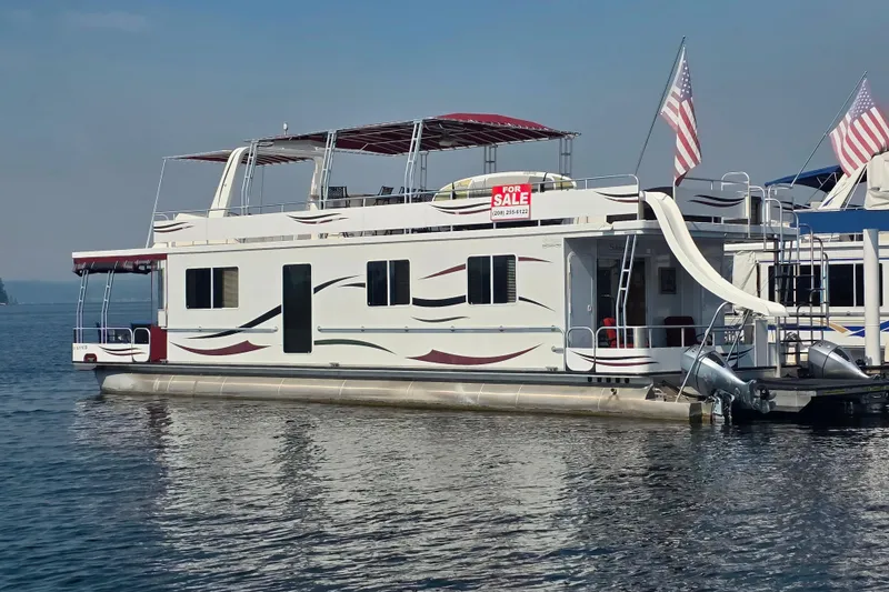 Slide: The Image of Houseboat for sale, 2015 Sailabration 64, with slide and American flags on a lake. - 9