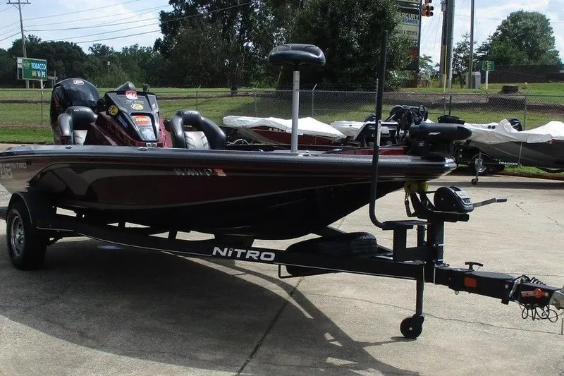 Slide: The Image of 2023 Nitro Z18 boat on trailer, parked outdoors, showcasing sleek design and modern features. - 7