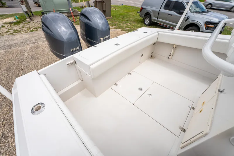 Slide: The Image of 2004 Jupiter 27fs boat with twin 200 horsepower engines, spacious deck, and storage compartments. - 11