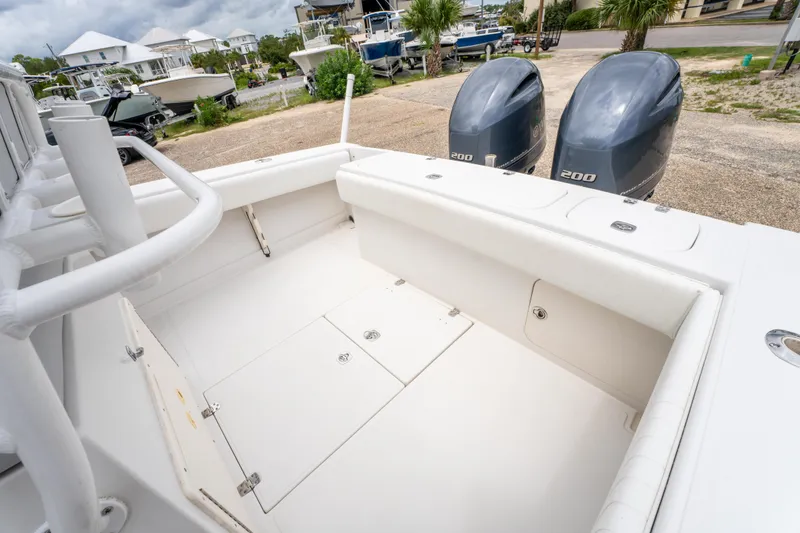 Slide: The Image of 2004 Jupiter 27fs boat with dual engines, spacious deck, and white seating. - 12