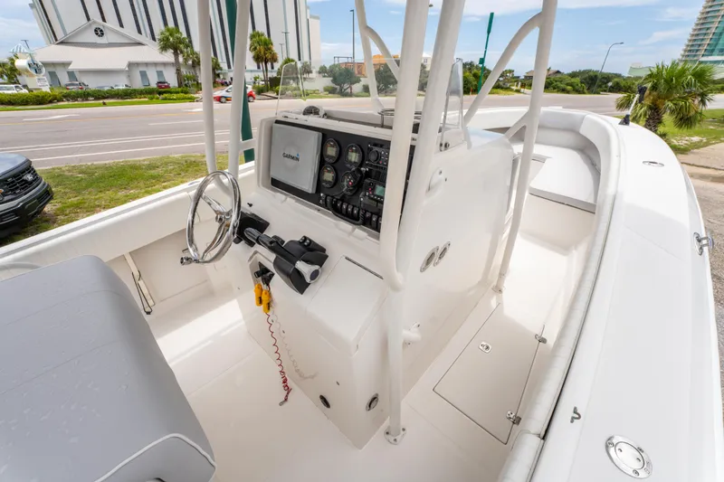 Slide: The Image of 2004 Jupiter 27fs boat cockpit with steering wheel and navigation equipment. - 17
