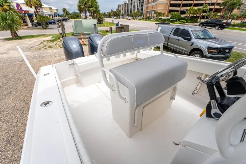 Slide: The Image of 2004 Jupiter 27fs boat interior with seating and dual outboard motors. - 18