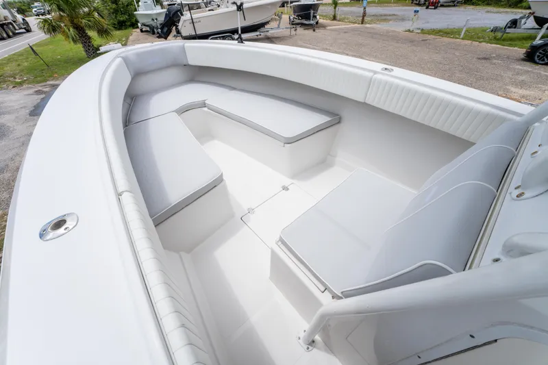 Slide: The Image of 2004 Jupiter 27fs boat interior with white cushioned seating and spacious deck. - 22