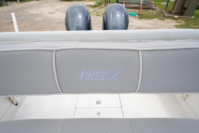 Slide: The Image of 2004 Jupiter 27fs boat seat with logo, featuring dual outboard motors in the background. - 27