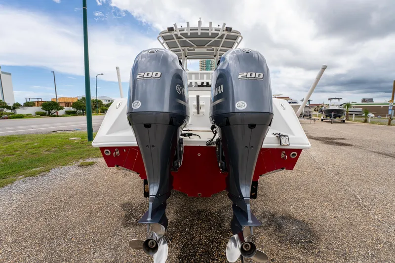 Slide: The Image of 2004 Jupiter 27fs boat with dual Yamaha 200 outboard engines, parked outdoors. - 7