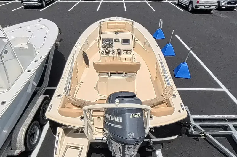 Slide: The Image of 2014 Scout 195 Sportfish boat with Yamaha 150 engine in parking lot. - 3