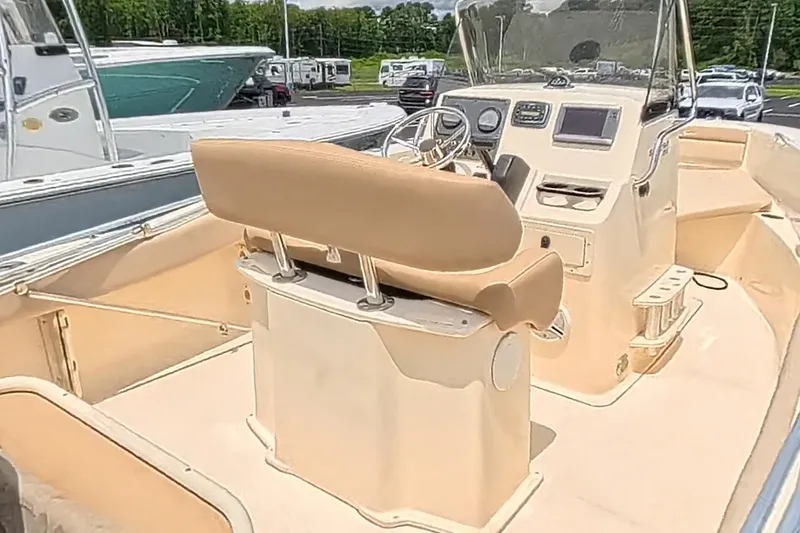 Slide: The Image of 2014 Scout 195 Sportfish boat interior with helm, seating, and dashboard controls. - 7
