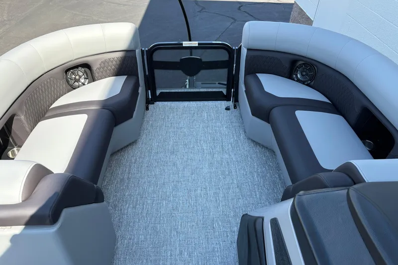 Slide: The Image of Interior of 2026 Premier 210 Sunsation RF pontoon boat with stylish seating and speakers. - 12