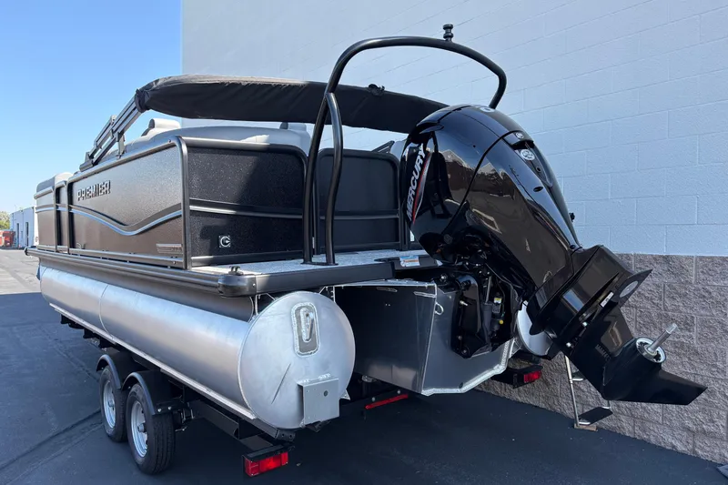 Slide: The Image of 2026 Premier 210 Sunsation RF pontoon boat with Mercury outboard motor, parked on trailer. - 2