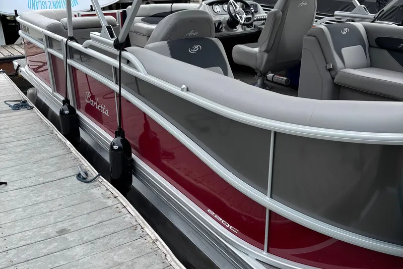 Slide: The Image of 2025 Barletta ARIA 22QC pontoon boat docked, featuring sleek red and gray design. - 5