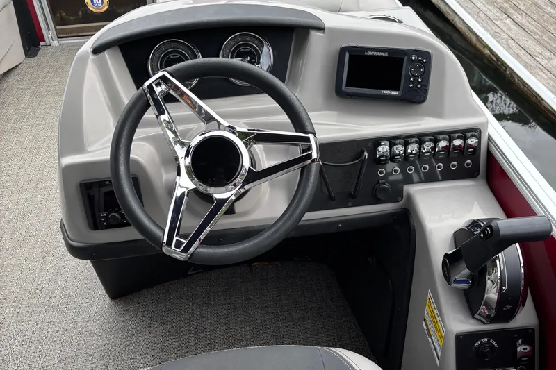 Slide: The Image of 2025 Barletta ARIA 22QC boat dashboard with steering wheel and control panel. - 6