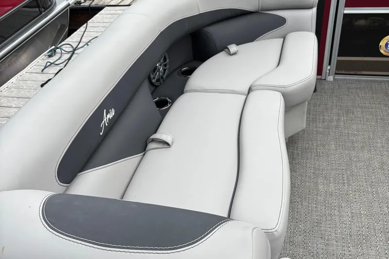 Slide: The Image of 2025 Barletta ARIA 22QC boat interior with plush seating and cup holders. - 8