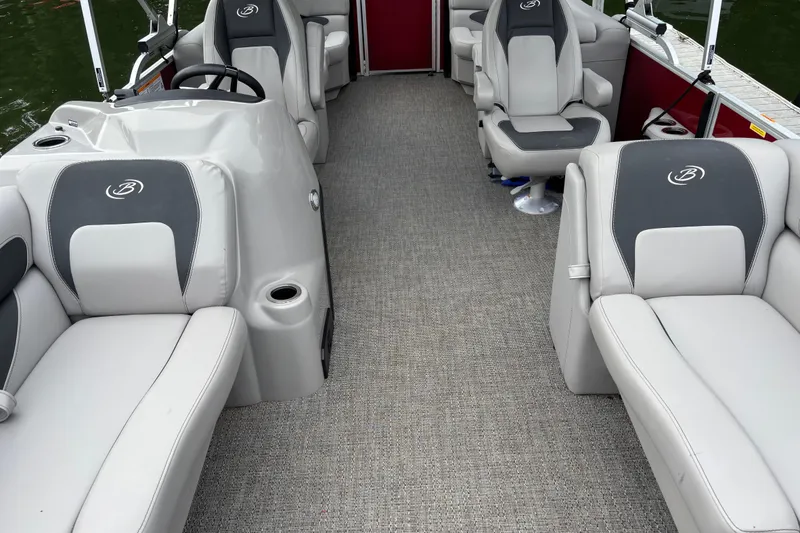 Slide: The Image of 2025 Barletta ARIA 22QC pontoon boat interior with gray seating and steering console. - 9