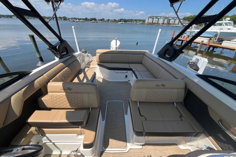 Slide: The Image of 2021 Sea Ray SDX 270 Outboard boat interior with luxurious seating and scenic waterfront view. - 11