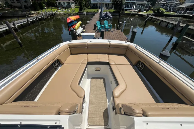 Slide: The Image of 2021 Sea Ray SDX 270 Outboard boat with spacious tan seating at a dock. - 18