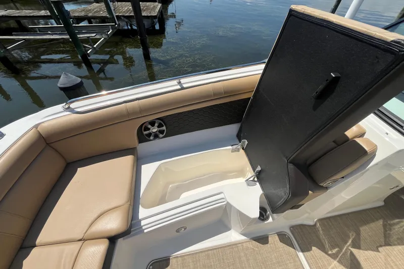 Slide: The Image of 2021 Sea Ray SDX 270 Outboard interior with tan seating and storage compartment. - 22