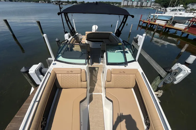 Slide: The Image of 2021 Sea Ray SDX 270 Outboard boat with tan seating, docked on calm water. - 24