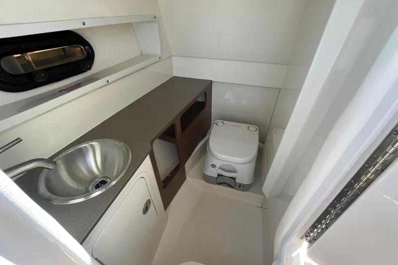 Slide: The Image of 2021 Sea Ray SDX 270 Outboard boat interior with sink and compact toilet. - 26