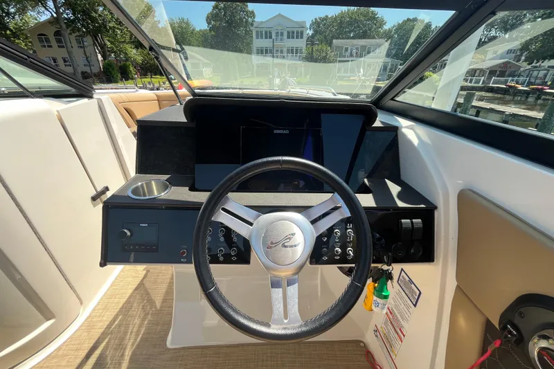 Slide: The Image of 2021 Sea Ray SDX 270 Outboard helm with steering wheel and control panel. - 8