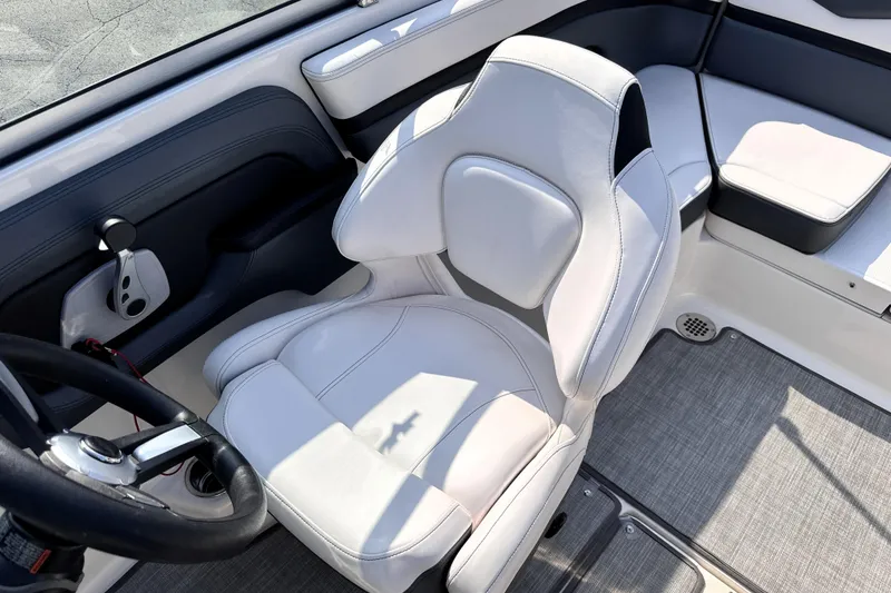 Slide: The Image of 2019 Chaparral Vortex 203 VRX boat interior with white seating and steering wheel. - 14