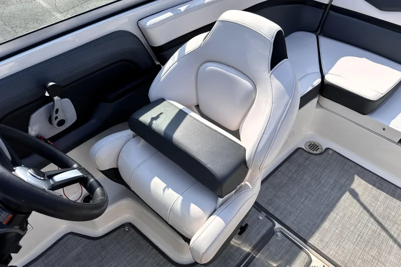 Slide: The Image of 2019 Chaparral Vortex 203 VRX boat interior with white captain's seat and steering wheel. - 15