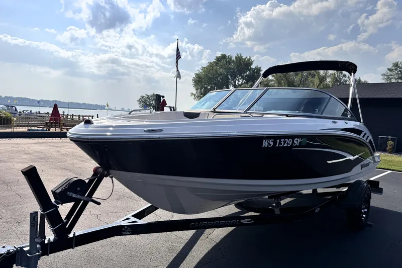 Slide: The Image of 2019 Chaparral Vortex 203 VRX boat on trailer, parked near a scenic waterfront. - 2