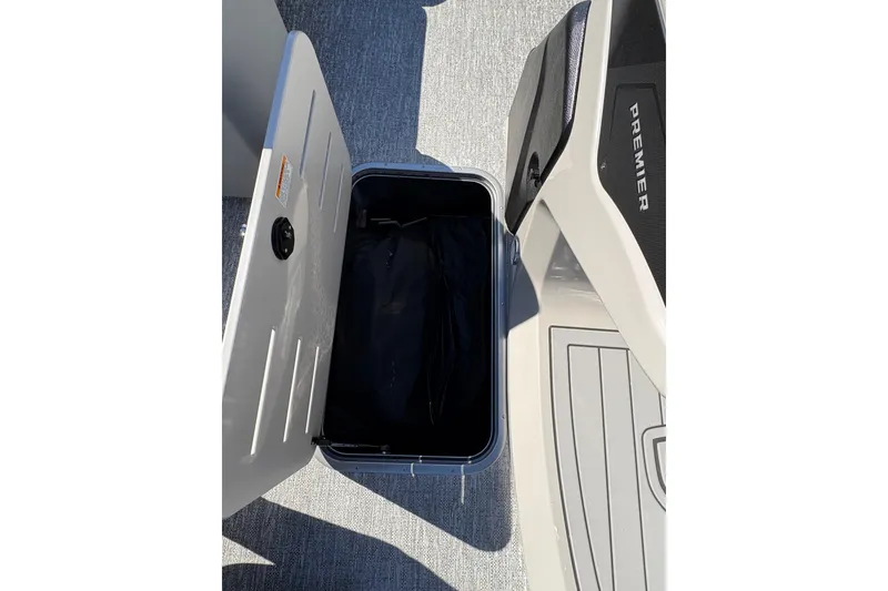 Slide: The Image of Open storage compartment on 2026 Premier 210 Sunsation RF boat deck. - 12
