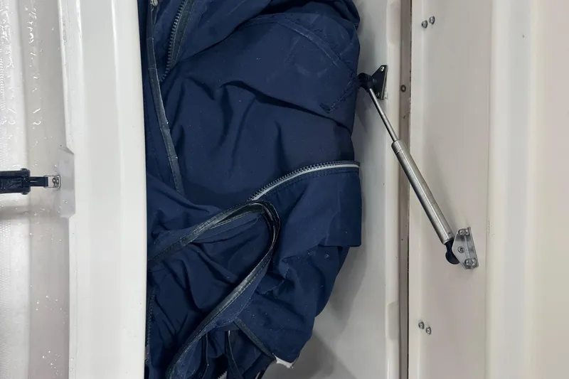 Slide: The Image of Storage compartment with blue fabric inside a 2000 Grady-White Fisherman 180 boat. - 11
