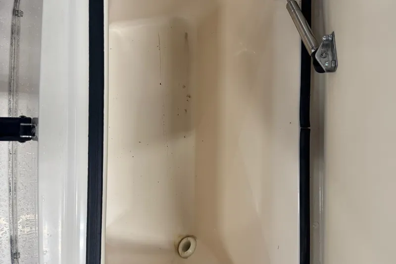 Slide: The Image of Grady-White Fisherman 180 boat storage compartment, 2000 model, with open lid and drain. - 12