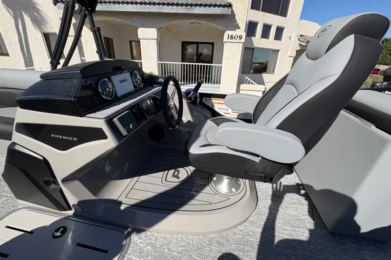 Slide: The Image of 2026 Premier 230 SunSation RF boat helm with modern controls and comfortable captain's chair. - 10