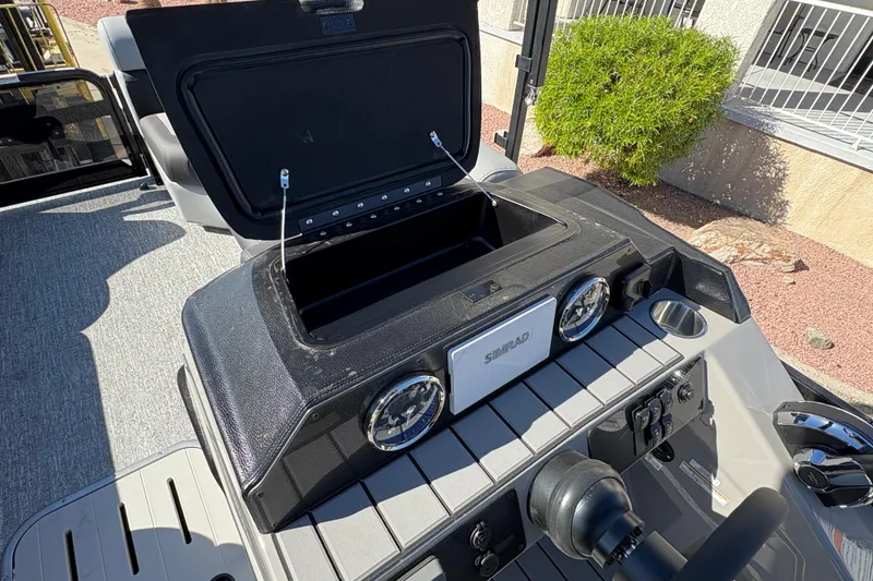 Slide: The Image of Dashboard of 2026 Premier 230 SunSation RF boat with open storage compartment. - 11