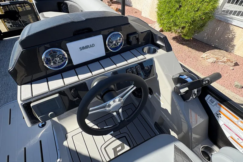 Slide: The Image of 2026 Premier 230 SunSation RF boat dashboard with steering wheel and Simrad display. - 9