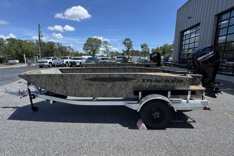 Slide: The Image of 2026 Tracker Grizzly 1650 T Prairie Wings Edition boat on trailer, outdoors under blue sky. - 4
