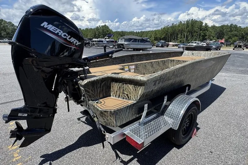 Slide: The Image of 2026 Tracker Grizzly 1650 T Prairie Wings Edition boat with Mercury engine on trailer. - 6