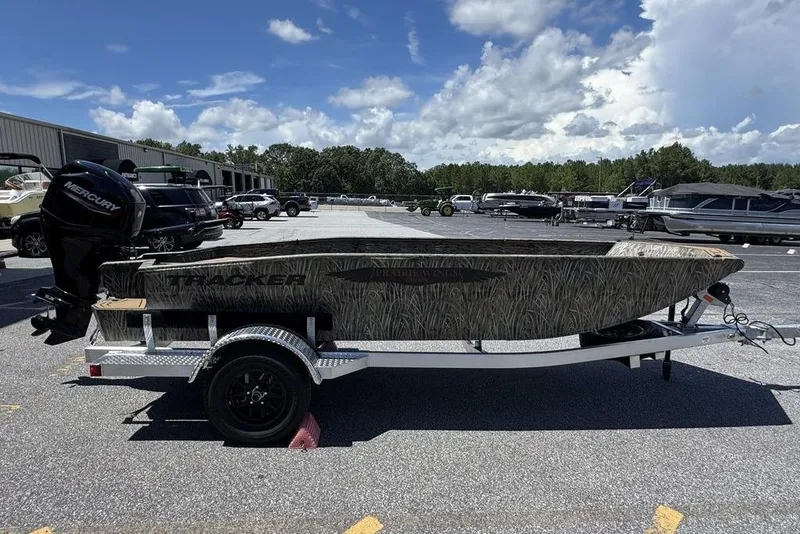 Slide: The Image of 2026 Tracker Grizzly 1650 T Prairie Wings Edition boat on trailer, parked outdoors. - 8