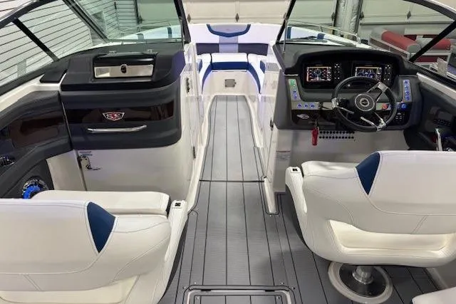 Slide: The Image of Interior view of 2023 Chaparral 307 SSX boat, featuring modern dashboard and seating. - 10