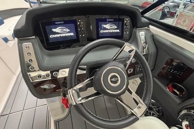 Slide: The Image of 2023 Chaparral 307 SSX dashboard with dual Simrad displays and sleek steering wheel. - 13