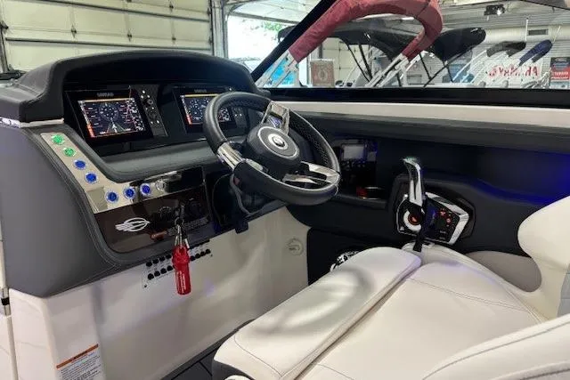 Slide: The Image of 2023 Chaparral 307 SSX boat cockpit with modern controls and steering wheel. - 15