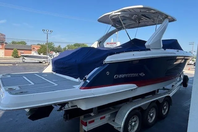 Slide: The Image of 2023 Chaparral 307 SSX boat on a trailer, covered and parked outdoors. - 21